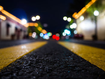 Illuminated street lights on road at night