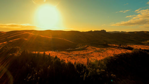 Scenic view of landscape against sky during sunset