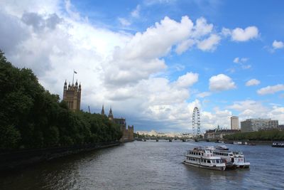 Boats in river with city in background