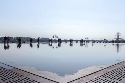 Swimming pool in city against sky