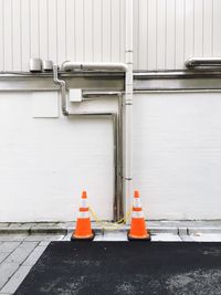 Garbage can against orange wall