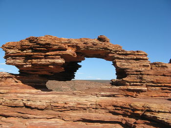 Rock formation against clear blue sky