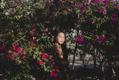 Portrait of woman holding pink flower