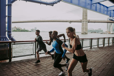 People on bridge against sky