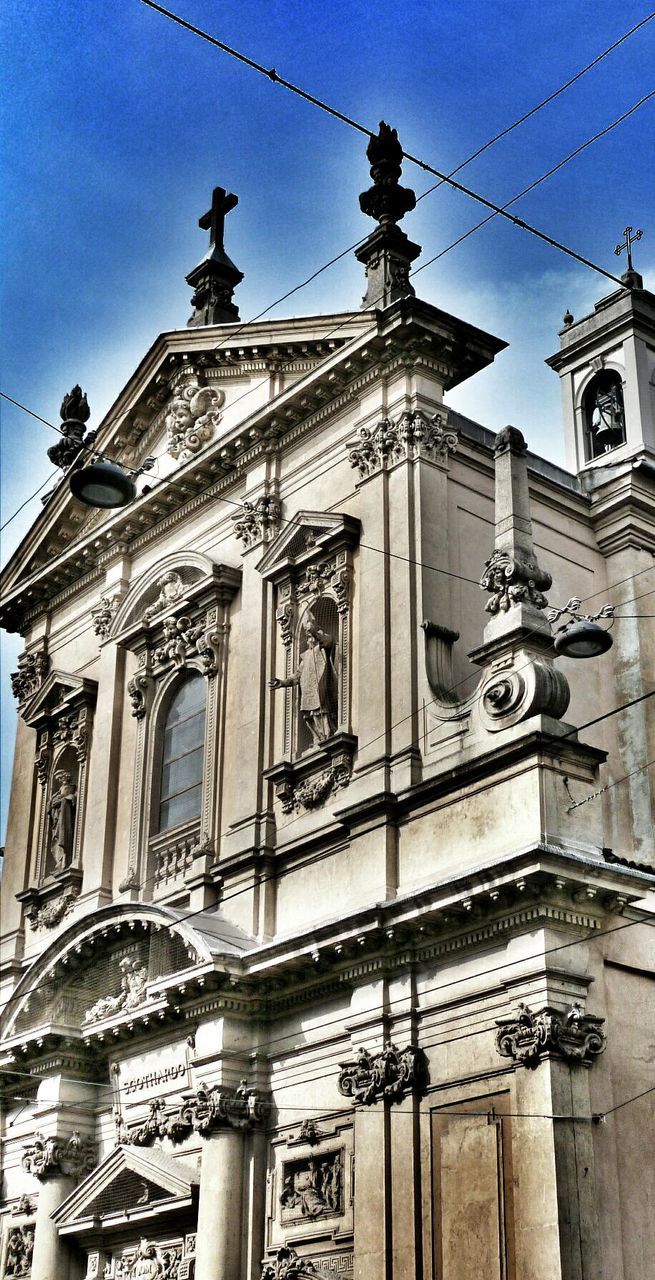 architecture, low angle view, building exterior, built structure, religion, church, place of worship, sky, spirituality, blue, travel destinations, history, cathedral, cross, day, facade, no people, outdoors