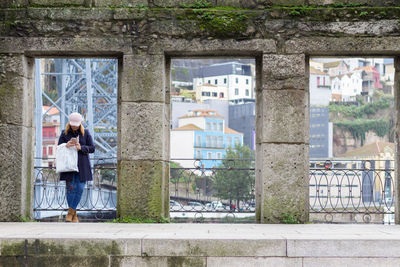 Woman standing by window