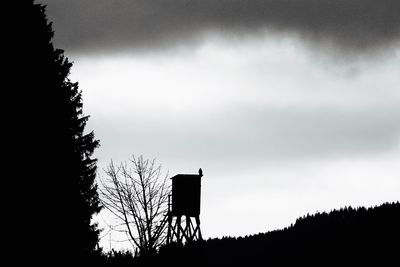 Low angle view of silhouette trees against sky at dusk