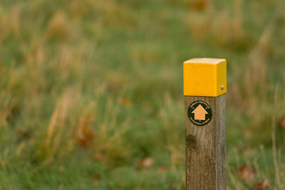 Close-up of directional sign on field