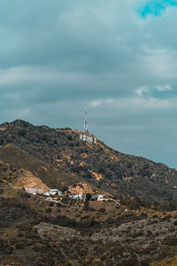 Scenic view of building and mountains against sky