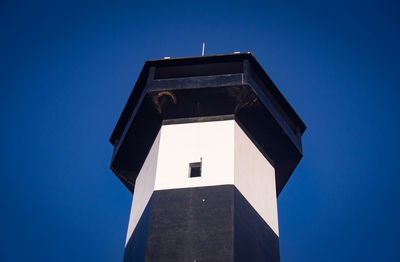 Low angle view of building against clear blue sky