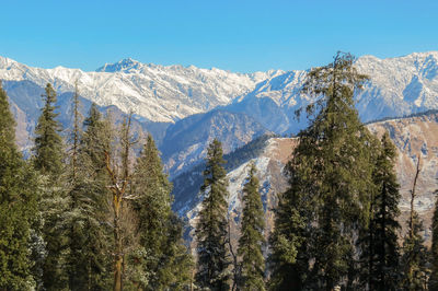 Scenic view of snowcapped mountains against clear sky