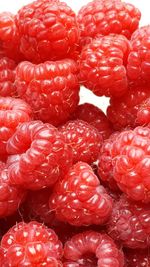 Full frame shot of raspberries against white background