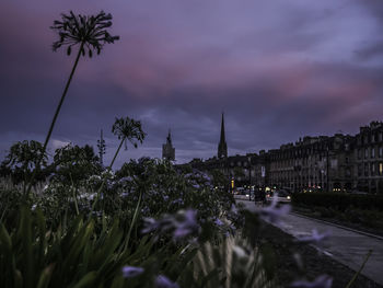 Panoramic view of buildings against cloudy sky