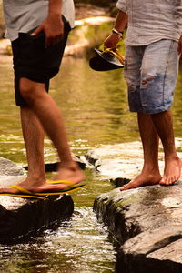 Low section of men standing on rock