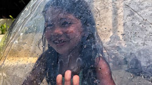 Close-up portrait of wet woman in rainy season