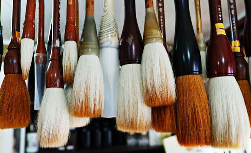 Close-up of paintbrushes in row