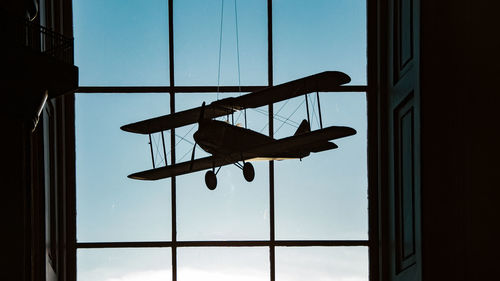 Low angle view of silhouette man against sky