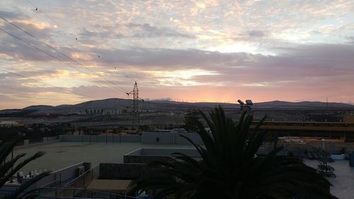 View of cityscape against cloudy sky