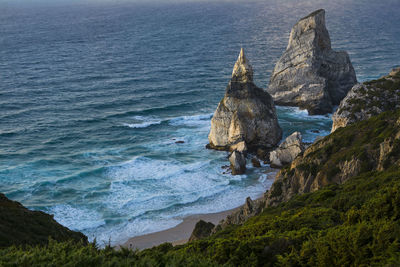 Rock formation in sea against sky