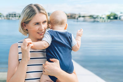 Happy mother and daughter in water