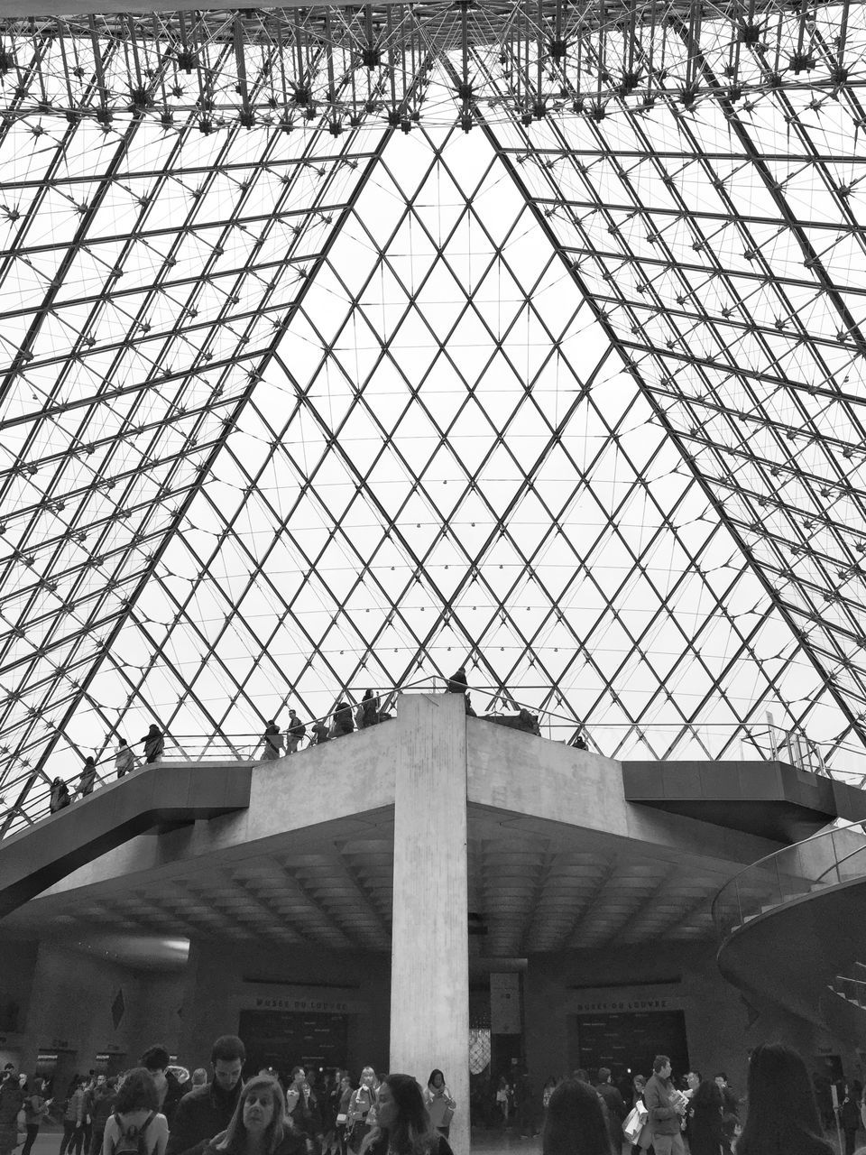 LOW ANGLE VIEW OF PEOPLE IN MODERN BUILDING