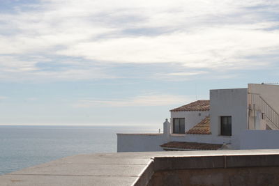 Building by sea against sky