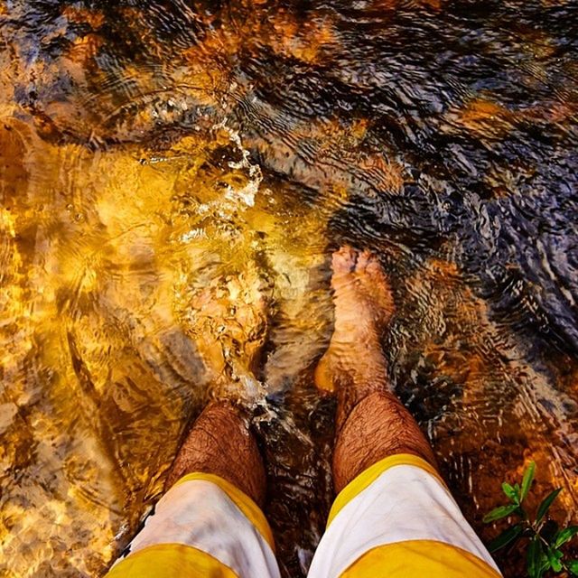 low section, person, personal perspective, water, human foot, shoe, high angle view, lifestyles, standing, leisure activity, unrecognizable person, men, nature, footwear, part of, outdoors, rippled