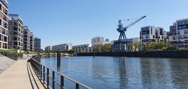 Bridge over river against buildings in city