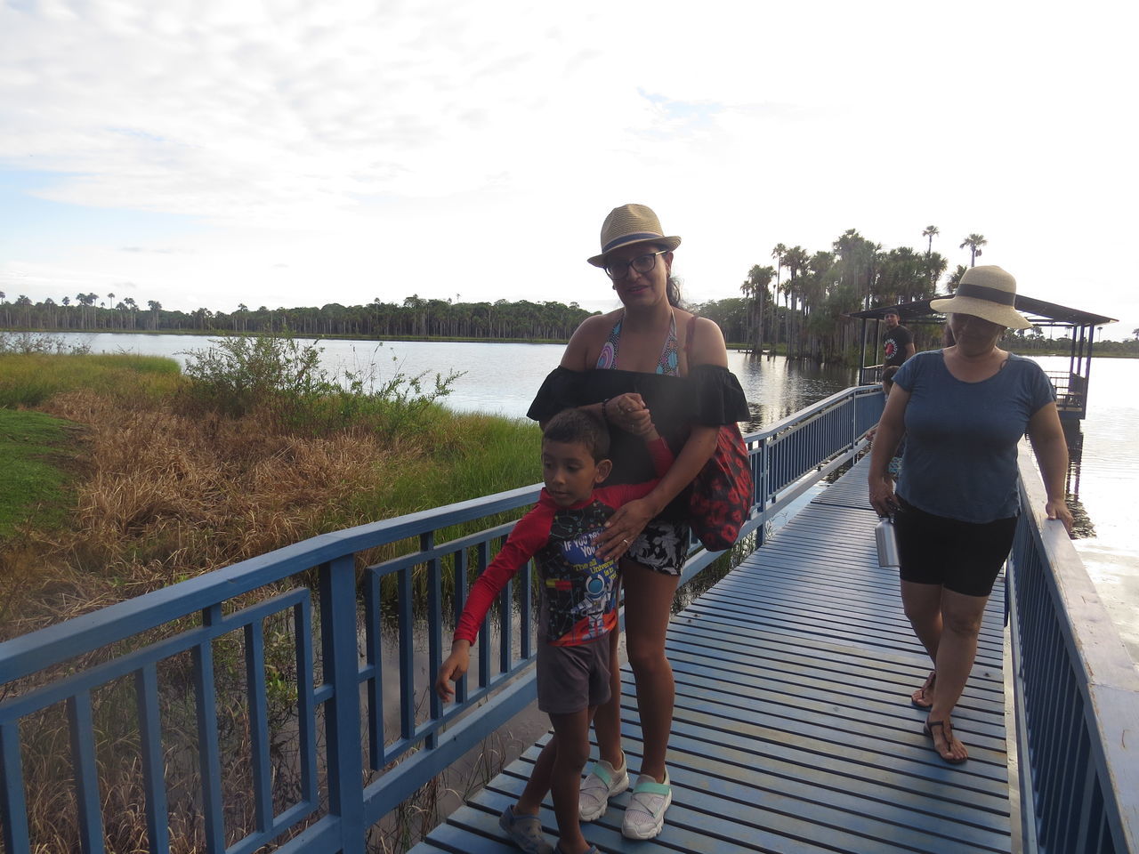 real people, railing, lifestyles, women, men, leisure activity, togetherness, group of people, full length, childhood, sky, casual clothing, females, family, people, males, child, adult, nature, water, positive emotion, outdoors