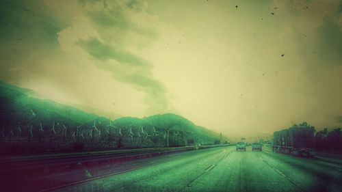 Road in city against storm clouds