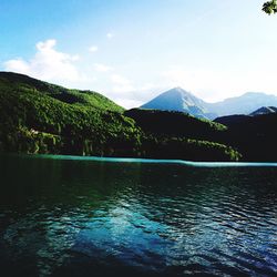 Scenic view of lake and mountains against sky