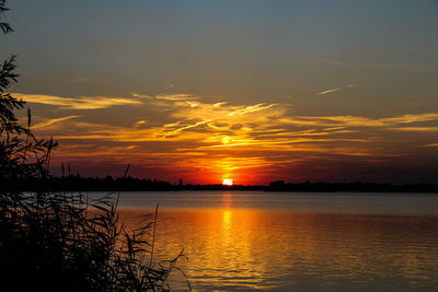 Scenic view of lake against romantic sky at sunset