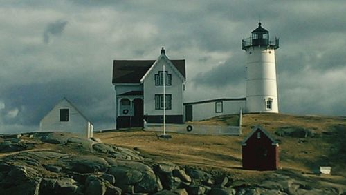 Lighthouse against cloudy sky