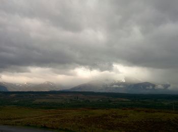 Scenic view of landscape against cloudy sky