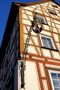 Low angle view of street light against building