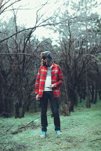 Full length of man standing in forest