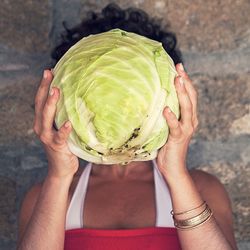 Midsection of woman holding cabbage