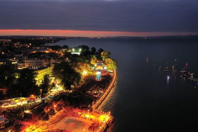 High angle view of illuminated cityscape against sky at night