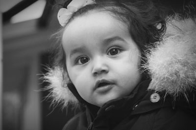 Close-up portrait of cute girl in warm clothing during winter