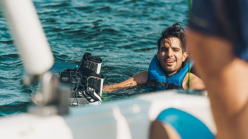 Man photographing against sea