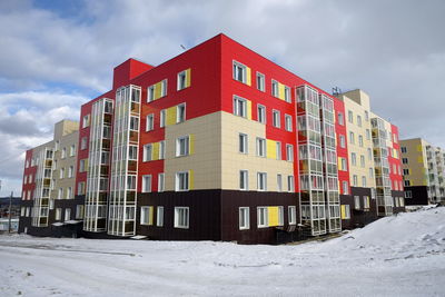 A new residential apartment building, beautifully lined with panels, with glazed balconies.