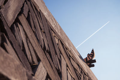 Low angle view of traditional windmill against clear sky