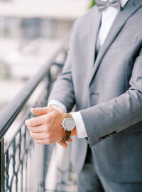 Midsection of businessman using mobile phone