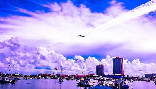 View of cityscape against cloudy sky