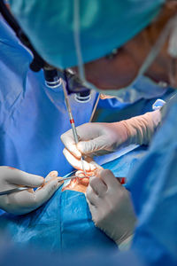 Midsection of surgeons performing surgery