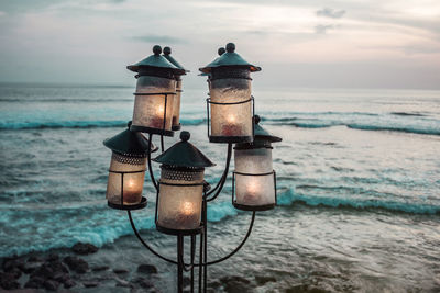 Outside lanterns with candles on ocean background. romantic sunset on sea coast. bali, canggu.