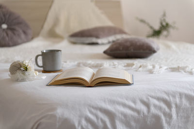 Open a book, mug, cozy winter day at home. christmas, relaxation and hygge background