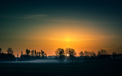 A beautiful spring landscape with rising sun through the mist. 