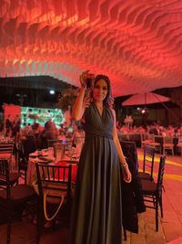 Rear view of woman standing at restaurant