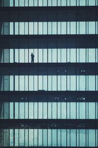 Silhouette man working at office building